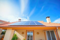 clay roof with solar panels in a sunny setting